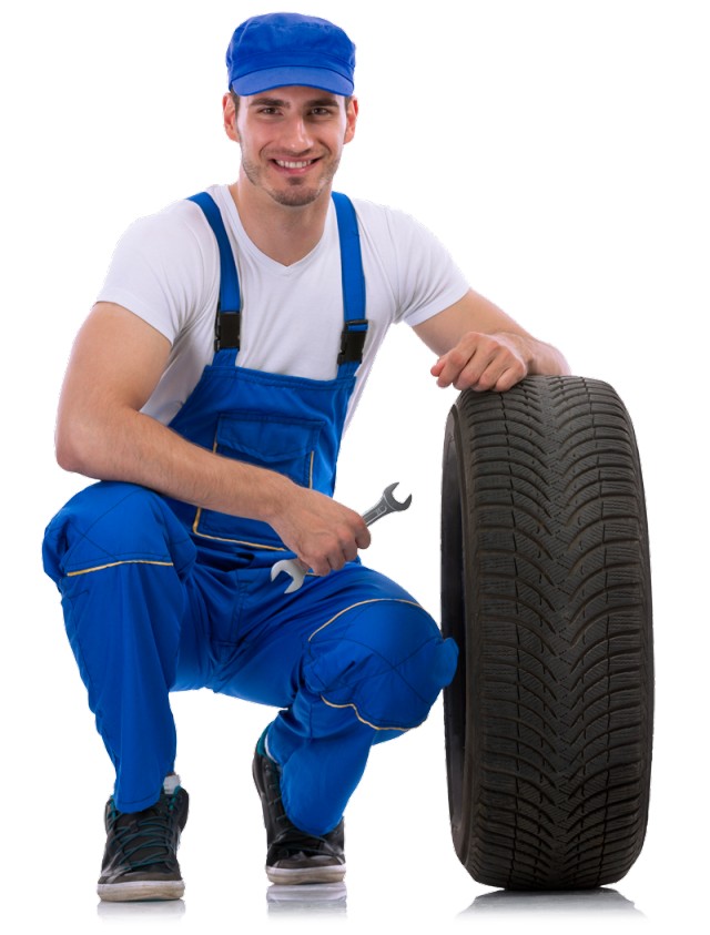 young mechanic holding a car tyre