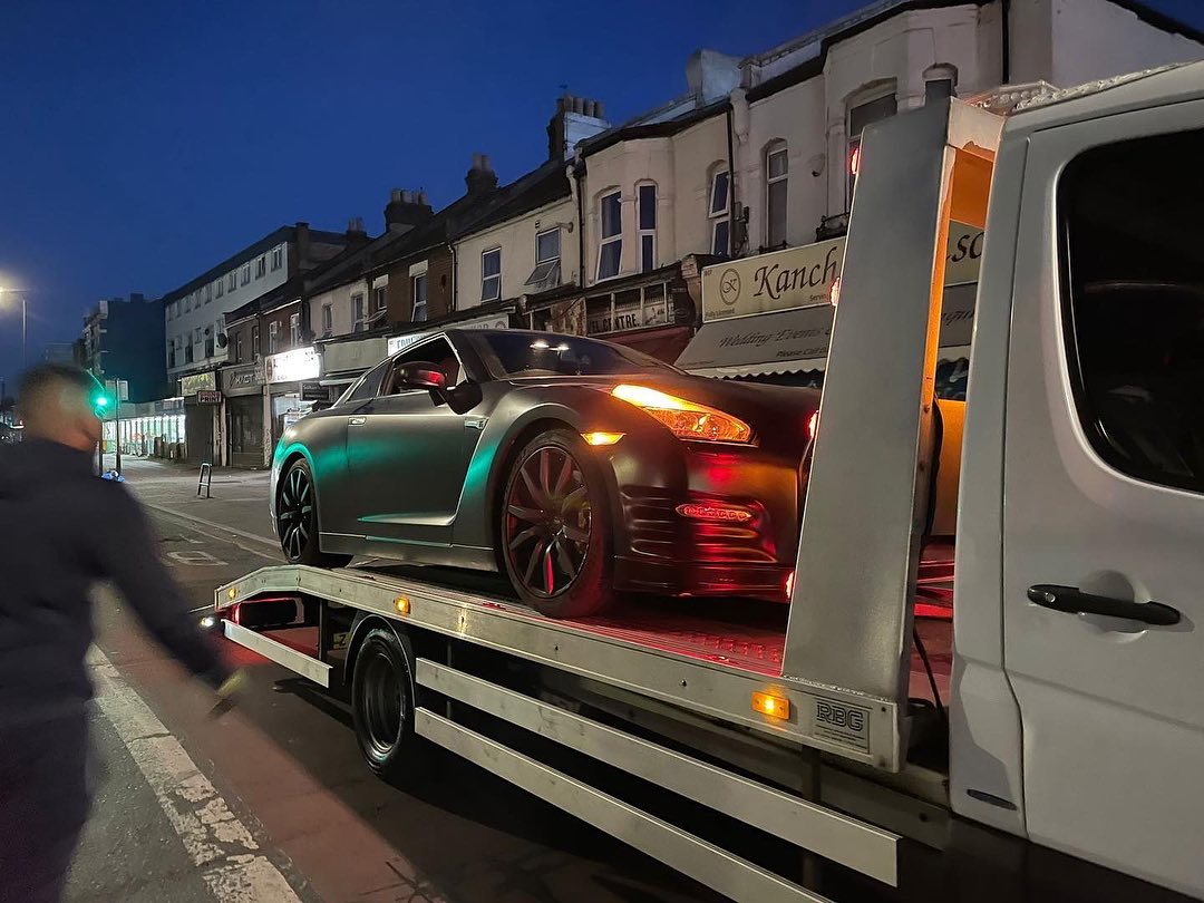 luxury car towing at night