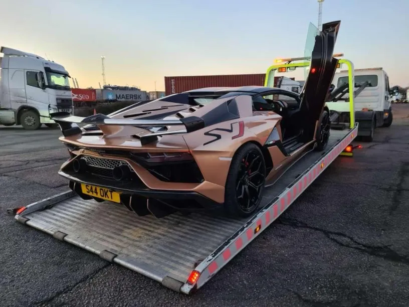 Lamborghini Aventador SVJ being transported on a flatbed tow truck