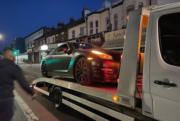 luxury car towing at night